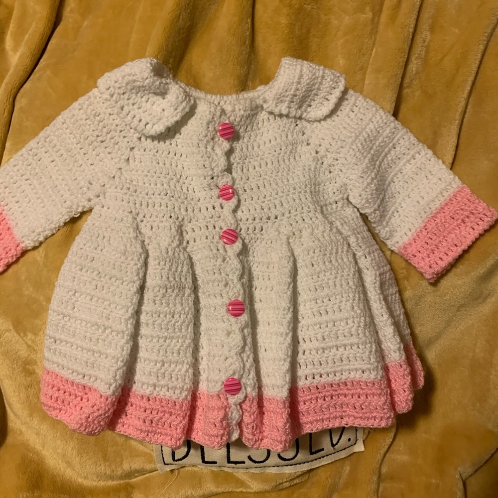 White and pink sweater for a baby girl